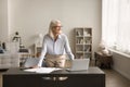 Happy successful senior freelance business woman standing at home workplace Royalty Free Stock Photo
