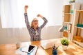 Happy successful woman in glasses achiving goal in her office Royalty Free Stock Photo