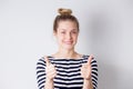 Happy and successful young business woman shows thumbs up with two hands and smiles on white background Royalty Free Stock Photo