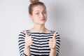 Happy and successful young business woman shows thumbs up with two hands and smiles on white background. Positive emotions, facial Royalty Free Stock Photo