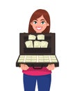 Happy successful young woman holding briefcase full of money banknotes. Businesswoman holds up a suitcase full of currency notes. Royalty Free Stock Photo