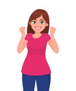 Happy successful young woman raising hands. Woman celebrating success, gesturing raised fists up. Human emotion and body language. Royalty Free Stock Photo