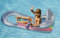 Happy summer vacation. Child in pool. Boy swimming at swimmingpool. Funny kid on inflatable rubber mattress. Kids Royalty Free Stock Photo