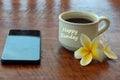 Sunday coffee with bali frangipani flower, a white cup of morning coffee with text card greeting on it. Happy Sunday.