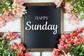 Happy Sunday text on blackboard with flower bouquet decoration Royalty Free Stock Photo