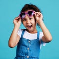 Happy, sunglasses and portrait of a child in studio with a positive, shocked and excited face expression. Happiness