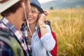 Happy sunny day.Smiling couple travelling in nature and sharing headphones listening music