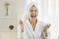 Happy excited young woman doing her skin care, applying facial cream and laughing Royalty Free Stock Photo