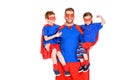 happy super father holding smiling kids in masks and cloaks