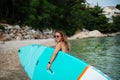 Happy surfer girl walking with board on the sandy beach. Water sports. Healthy Active Lifestyle. Summer Vacation concept Royalty Free Stock Photo