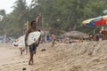 Happy surfer walking on the beach