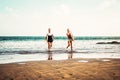 Happy surfers couple running out water after ride on waves - Young people having fun surfing together Royalty Free Stock Photo