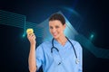 Happy surgeon holding an apple and smiling at camera Royalty Free Stock Photo