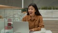 Happy surprised Asian chinese korean girl businesswoman in cafe winner woman winning prize on laptop online bet Royalty Free Stock Photo