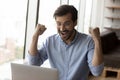 Happy surprised businessman excited with good news, using laptop Royalty Free Stock Photo