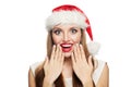 Happy surprised Christmas woman in Santa hat isolated on white background. Christmas and New Year portrait Royalty Free Stock Photo