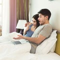 Happy couple watching movie on laptop in bed Royalty Free Stock Photo