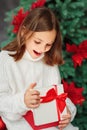 Happy surprised cute little girl opening new year gift Royalty Free Stock Photo