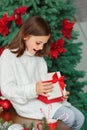 Happy surprised cute little girl opening new year gift Royalty Free Stock Photo