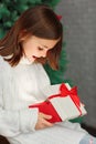 Happy surprised cute little girl opening new year gift Royalty Free Stock Photo