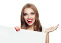 Happy surprised model woman showing open hand and holding white empty paper signboard isolated on white background Royalty Free Stock Photo