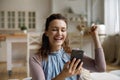 Happy surprised smartphone user receiving amazing good news on smartphone