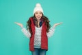 Happy surprised teen girl wear warm clothes. winter kid fashion. child with long curly hair in knitted hat. cold season Royalty Free Stock Photo