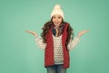 happy surprised teen girl wear warm clothes. winter kid fashion. child with long curly hair in knitted hat. cold season Royalty Free Stock Photo