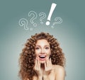 Happy surprised woman. Beautiful girl with long curly hair. Presenting your product. Positive emotion. Royalty Free Stock Photo