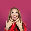 Happy surprised woman looking up and laughing portrait. Pretty excited girl on colorful bright pink background Royalty Free Stock Photo