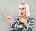 Happy Surprised Woman Showing Empty Copy Space on the Open Hand. Royalty Free Stock Photo