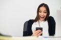 Happy surprising woman looking in mobile phone and reading message with open mouth Royalty Free Stock Photo