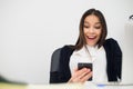 Happy surprising woman looking in mobile phone and reading message with open mouth Royalty Free Stock Photo