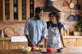 Happy sweet African American couple cooking fresh salad Royalty Free Stock Photo