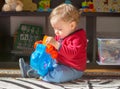 Happy sweet baby boy having fun playing with colorful toys, at home Royalty Free Stock Photo