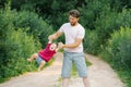 Happy and sweet moments of a summer walk in the park of a father and a little son