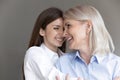 Happy sweet teen grandkid and senior grandma enjoying time together