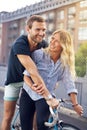 Happy Sweethearts Riding Bicycle at the Street