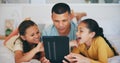 Happy, tablet and children networking with father in living room and relaxing together at home. Digital technology