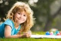 Happy talented boy artist painter. Child boy enjoying art and craft drawing in backyard or spring park. Children drawing Royalty Free Stock Photo