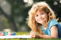 Happy talented boy artist painter. Child boy enjoying art and craft drawing in backyard or spring park. Children drawing Royalty Free Stock Photo