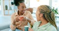 Happy, talking and women with coffee on the sofa for gossip, secret or conversation in a house. Excited, relax and a Royalty Free Stock Photo