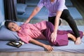 Happy woman having Thai massage in spa