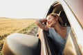 Happy Tattooed Girl Enjoying Road Trip, Young Woman Relaxing and Looking Out the Car Window Royalty Free Stock Photo