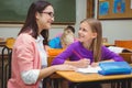 Happy teacher helping her students Royalty Free Stock Photo