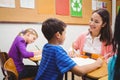 Happy teacher helping her students Royalty Free Stock Photo