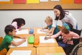 Happy teacher helping her students