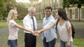 Happy teacher and multiracial students putting hands on pile, team building Royalty Free Stock Photo