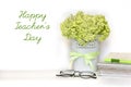 Happy Teacher`s day greeting card - bouquet of light green hydrangea branch in flower pot with satin ribbon, pile of notebooks,