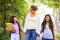 Happy teacher, students and holding hands walking to school in outdoor park for support or responsibility. Woman, person Royalty Free Stock Photo